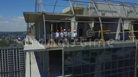 建筑施工现场高空观景与屋顶施工队伍探讨工程方案视频的预览图
