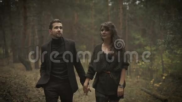 在森林里的小路上幸福的男人和女人在一起走着微笑的夫妇正漫步在视频的预览图