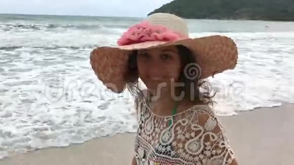 带着大太阳帽的女人在度假时眺望大海视频的预览图