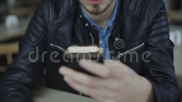 4K咖啡馆的年轻帅哥用智能手机视频的预览图