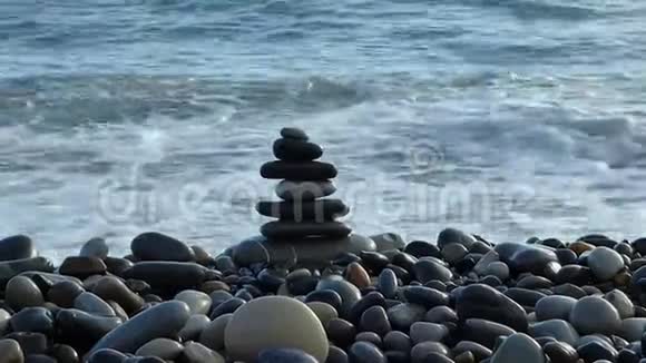 海滩上的禅石在海边的海浪中破碎视频的预览图