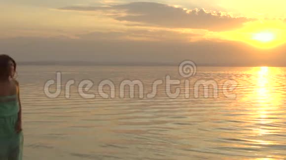 年轻的幸福夫妇在日落时在海滩上奔跑爱的概念视频的预览图
