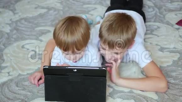 孩子们在平板电脑上看卡通视频的预览图