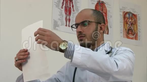 年轻的男医生仔细研究心脏造影视频的预览图