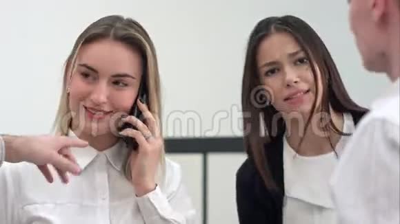 忙碌的办公室里的女人接电话用平板电脑视频的预览图