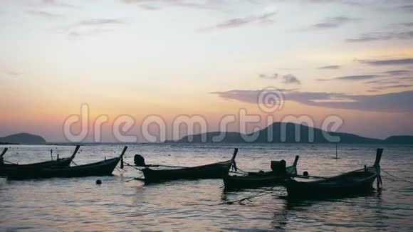 日出泰国普吉拉瓦海滩长尾渔船视频的预览图