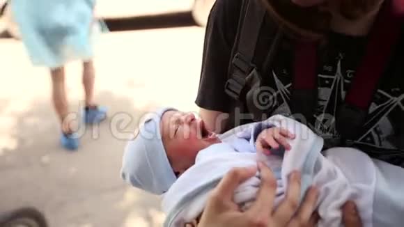 少年抱着一个刚出生的小男孩抱在怀里扭动它票价视频的预览图