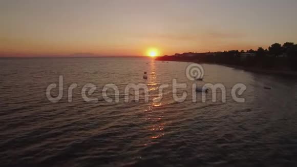 希腊海岸带船和度假村的空中日落海景视频的预览图
