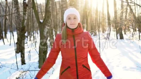 迷人的年轻女子在冬季公园里跳着愚蠢而有趣的舞蹈玩得很开心微笑着慢动作视频的预览图