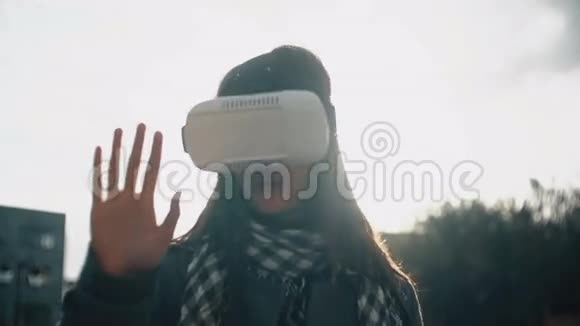 日落4k时女人在后光中使用虚拟现实眼镜视频的预览图