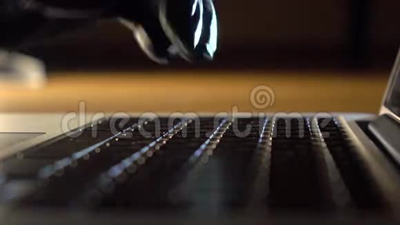 戴黑色手套的人在笔记本电脑键盘上打字并使用触摸板抢劫偷窃保密间谍概念视频的预览图