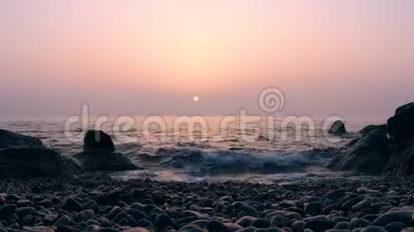 海面上有岩石的日出时间视频的预览图