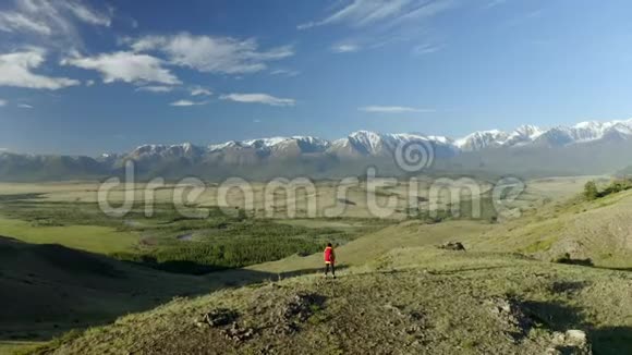 年轻女子徒步行走在山脊上到达山顶双臂张开视频的预览图