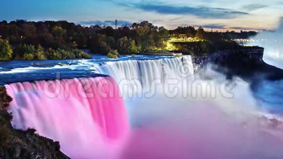 傍晚著名的尼亚加拉大瀑布聚光灯照亮瀑布是美丽的白色和粉红色的光视频的预览图
