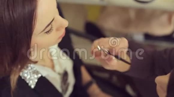 化妆师将眼影印在模特的眼睛上视频的预览图