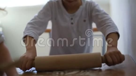 女儿和儿子都穿着白色T恤在同一张桌子上准备馅饼周末和家人在一起男孩和女孩卷视频的预览图