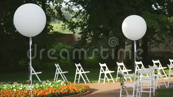 婚礼设置在花园公园婚礼外庆祝婚礼过道装饰一排排白色的木头空的视频的预览图