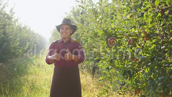 农夫站在花园里举起一双大手指的画像视频的预览图