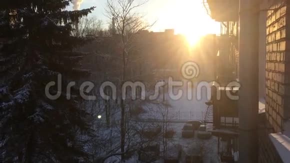 在雪域街道上的一栋公寓楼的俯视图太阳照耀着视频的预览图