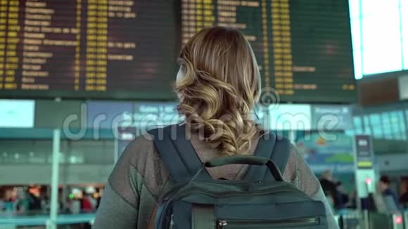 在机场看信息板的女人视频的预览图