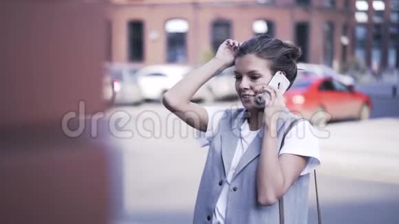年轻女子在街上用智能手机说话关门视频的预览图