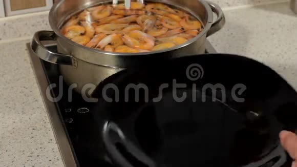 用平底锅煮虾子准备好的虾铺在盘子上准备海鲜视频的预览图