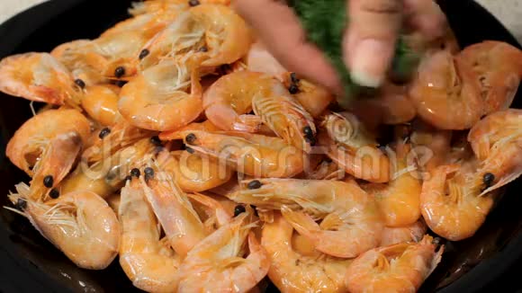 准备好的虾躺在盘子里洒下虾青菜尿尿女性的手是由准备好的虾来的视频的预览图