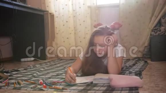 一个女孩她躺在地上在家画画视频的预览图