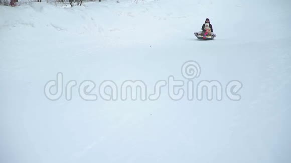 母亲和女儿骑在雪橇上视频的预览图