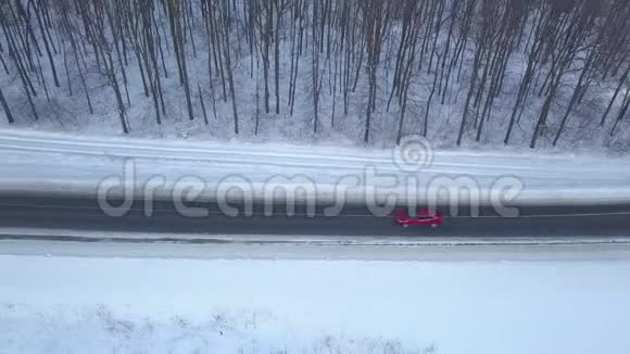 通过冬季森林道路行驶的汽车的鸟瞰图冬季景观视频的预览图