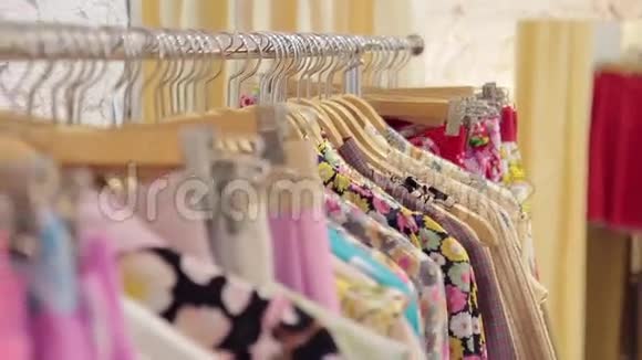 色彩鲜艳的女人衣服挂在商店的衣架上视频的预览图