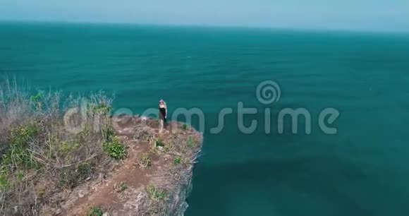 少女漫步在美丽的悬崖上的鸟瞰视频的预览图