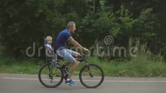 父亲和儿子在森林里骑自行车视频的预览图
