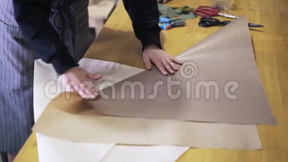 妇女花店折叠剪纸在桌子上包花视频的预览图