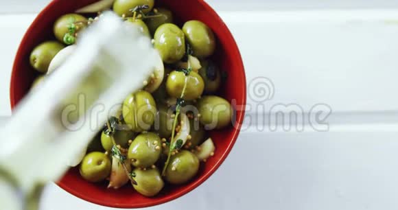 橄榄油倒在绿橄榄茶树上视频的预览图