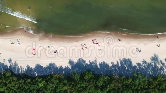 沙滩上有日光浴和海浪的鸟瞰图视频的预览图