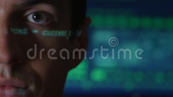 带有绿色代码字符的人程序员黑客画像在他脸上反射电脑屏幕上显示视频的预览图