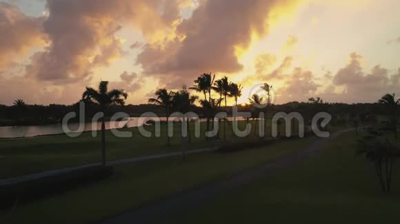蓬塔卡纳空中视频在高尔夫球场附近的湖面上日落视频的预览图