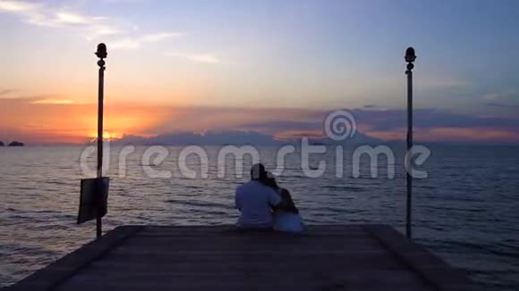 在码头上看日落的浪漫情侣视频的预览图
