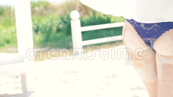 女人站在海滩上她的腿和屁股在沙子里慢慢地视频的预览图