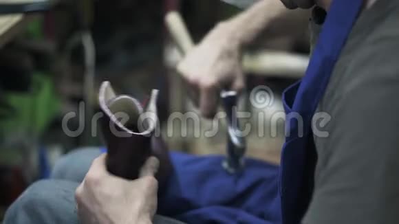 双手皮匠锤制女鞋侧视视频的预览图