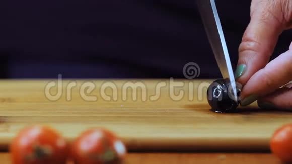 一个女人用菜刀切黑橄榄视频的预览图