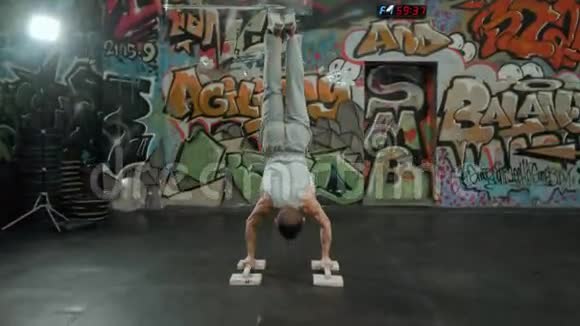 酷吸引人的年轻健美男子背部做运动训练支持倒立姿势桑巴塞萨纳与桑巴塞萨纳视频的预览图