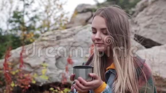 游客在山上喝一杯热水瓶里的茶视频的预览图
