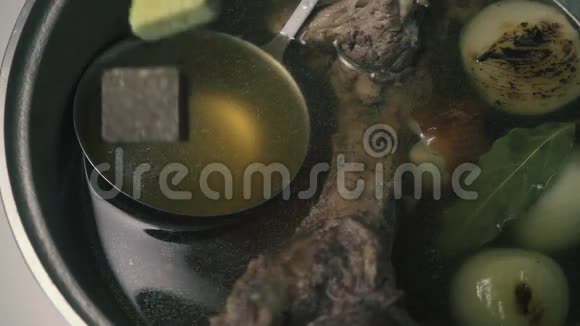 肉汤立方体掉进一个带有牛肉汤的平底锅里慢动作视频的预览图