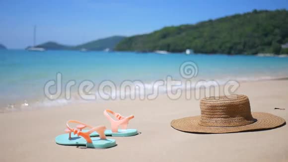 热带岛屿桑迪海滩上的帽子和拖鞋鞋HD旅行社网站背景资料泰国视频的预览图