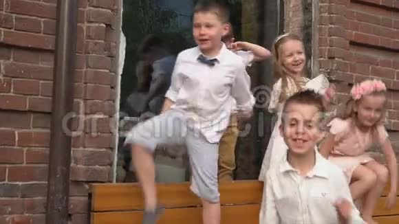 孩子们穿着复古的衣服在旧砖楼玩得开心视频的预览图