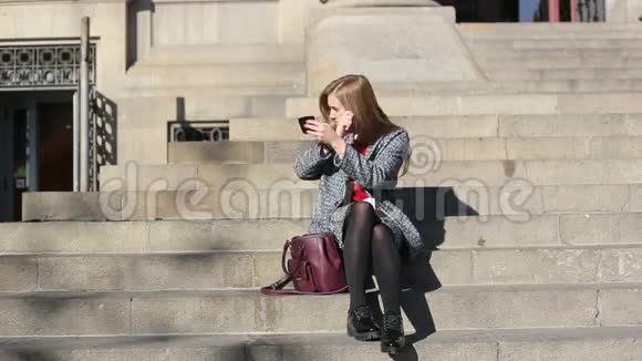 漂亮的女人看楼梯上的袖珍镜座视频的预览图
