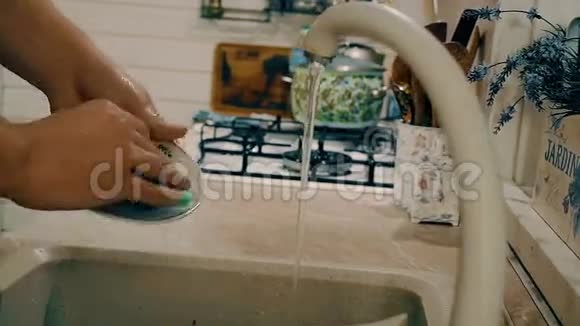 女人在厨房里用肥皂洗手带有侧面摄像机运动的特写镜头视频的预览图