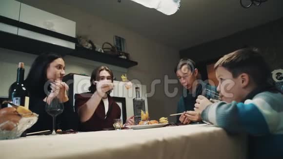 家人和朋友在餐桌上聊天吃寿司庆祝视频的预览图